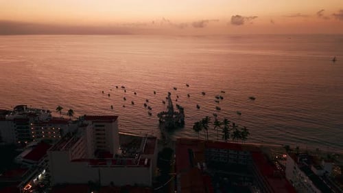 Romantic scenery at Los Muertos beach and pier at the golden hour in Puerto Vallarta, Mexico