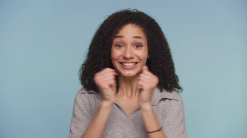 Excited Woman Cheering with Raised Fists