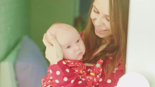Close Up of Mother Holding Infant Smiling