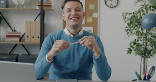 Slow Motion Portrait of Cheerful Young Businessman Smiling Looking at Camera in Workplace