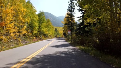 POV footage of driving in the Rocky Mountains of Colorado in fall season