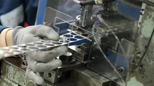 Worker Operating Power Press In Manufacturing Plant, close up