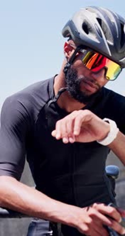 Man, bicycle and smart watch in city for training with timer, results or heart rate for cardio
