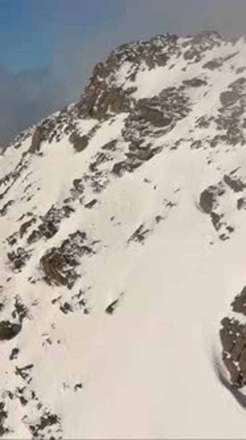 Snowy Mountain Peak With Rolling Clouds. British Columbia, Canada.