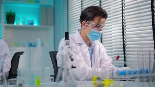 Asian male scientist working in the biotechnology research laboratory.