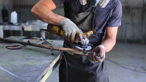 Metalworking Workshop The Master Grinds the Metal with a Grinding Machine Sparks