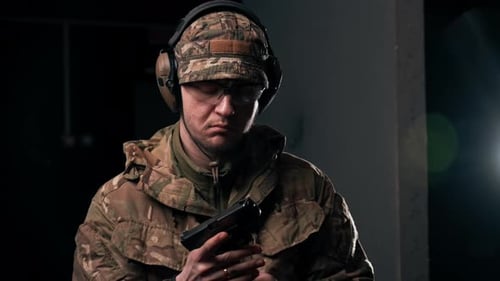 Closeup at a Professional Shooting Range a Military Trainer Takes Aim and Makes a Shot