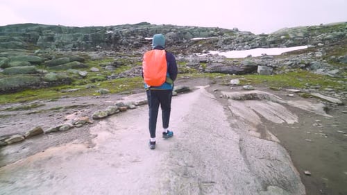 guy travels on a beautiful mountain road in norway