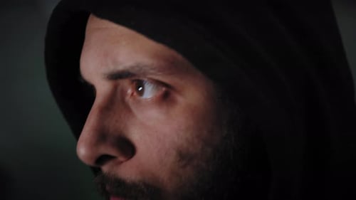 Young Adult Types at Keyboard in Dark Room