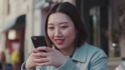 Portrait Young Asian Woman Use Phone Sitting Smile on Street Outdoor Hand Girl Shopping Internet