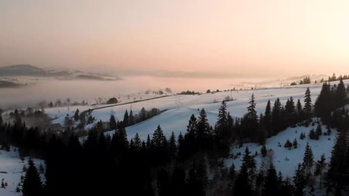 Aerial Mountain Sunset Over Winter Landscape