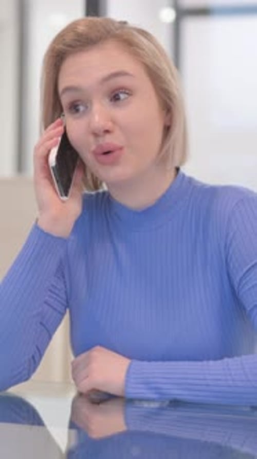 Young Woman Talking on phone in Office, vertical video