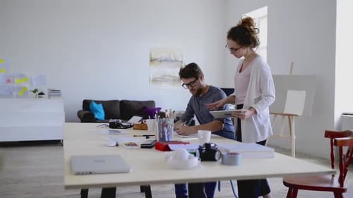 Young architects consulting a project together in a modern office