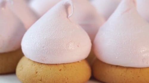 Close Up of Pink Cake with Berry Cream Meringue Rotates on Tray