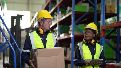 Warehouse Industrial and Logistics Companies. Dispatcher in uniform making inventory in storehouse.