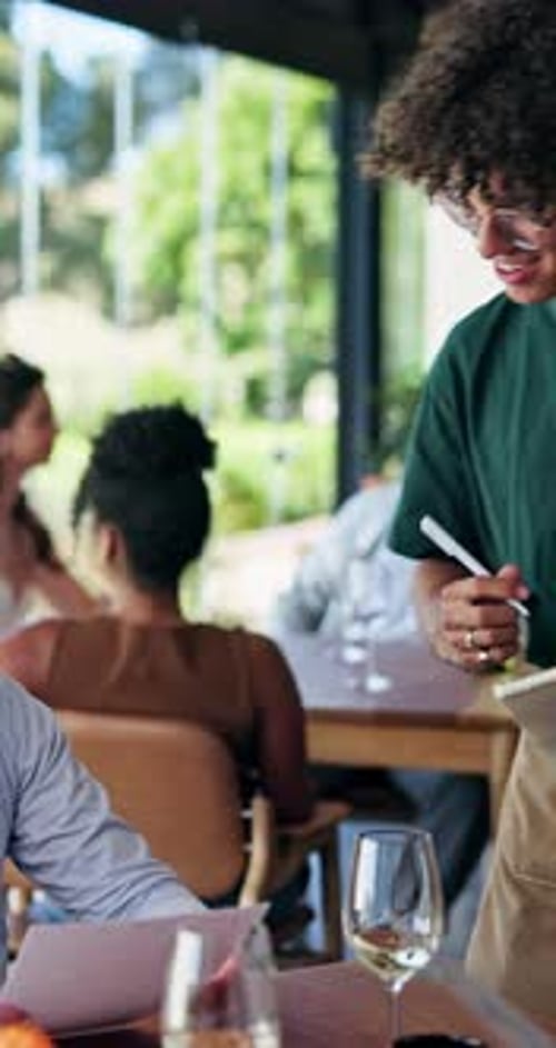Restaurant, waiter and couple with food order for fine dining, menu options and writing on notepad