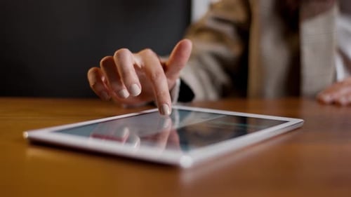 Hand Scrolling on Tablet Screen Close Up