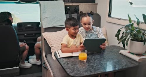 Kids Using Tablet Inside Camper Van