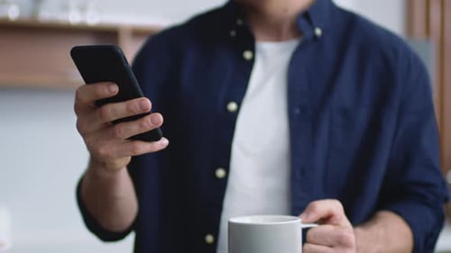 Man Typing on Phone at Home