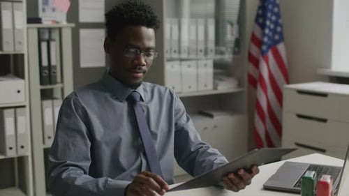 African American Visa Officer Interviewing Applicant at US Embassy