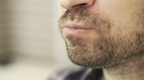 Bearded Young Man Biting a Green Apple at Home Healthy Eating Concept