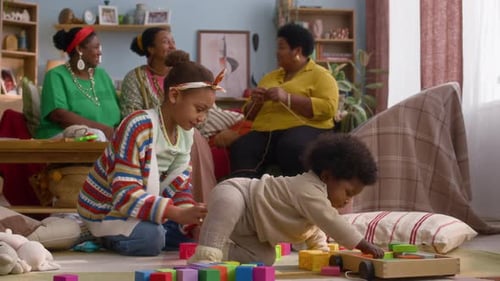 Family playing with colorful toy blocks in living room