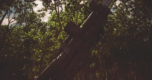 Captured in the Quiet Woods a Gun Resting Amidst Lush Greenery During Twilight