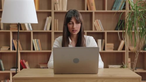 Professional Woman Working at Laptop in Home Office