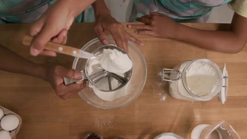Using Sifting Cup for Sifting Flour While Making Dough at Home