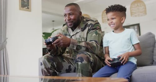 Father and Son Enjoy Playing Video Games Together