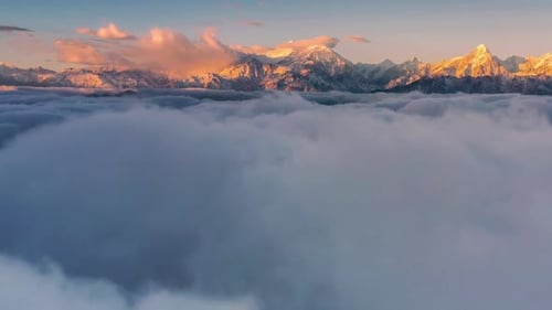 Picturesque Mountain Peaks Rising Above the Clouds at Sunrise