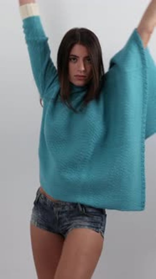 Teen Girl Dances Energetically in Oversized Sweater
