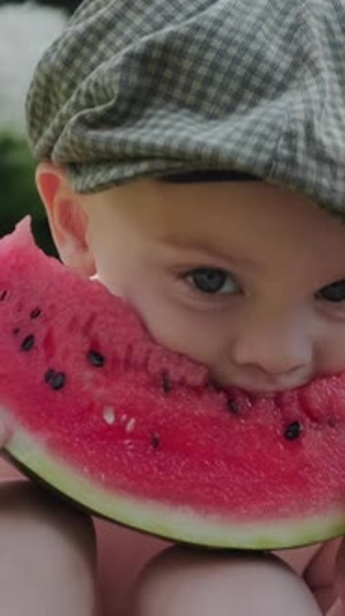 Boy With Cap Eats Watermelon Slice