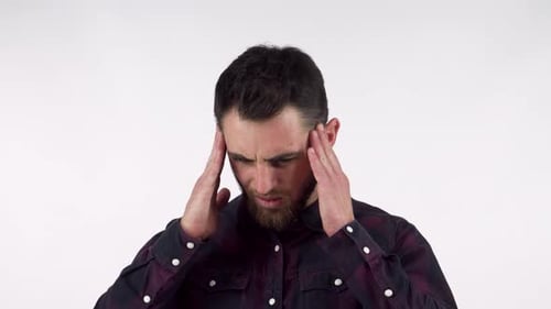 Man Massaging Temples Due to Headache, Plain Background