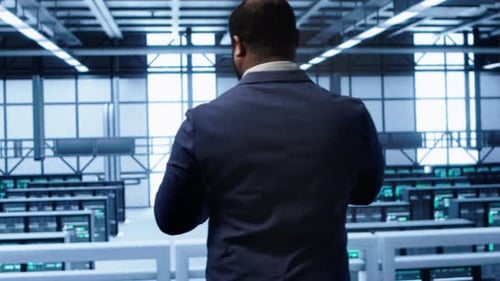 Technician Monitoring Server Room Supercomputers Doing Checkup