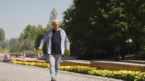 Frustrated man walking in the park.