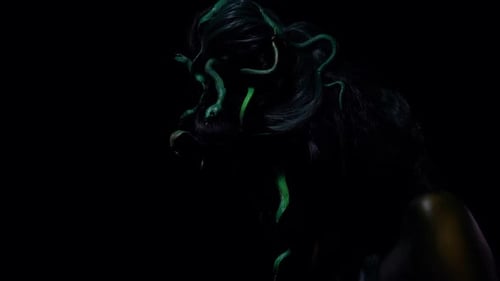 Captivating Medusa with Green Snakes Posing in the Dark