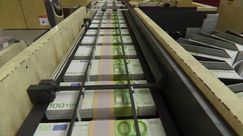 Euro banknotes move rapidly along automated money counting machine