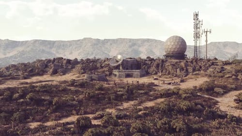 Abandoned Surveillance Base on a Rugged Landscape Under Clear Skies
