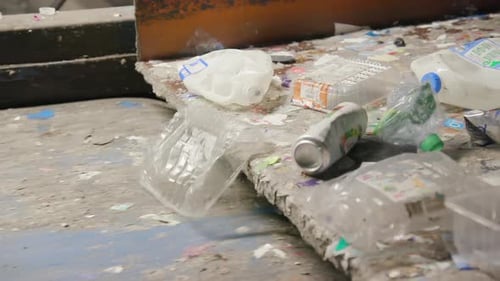 Recycling Plant For Plastic Bottles and Aluminum Cans on a Conveyor Belt. Slow Motion.