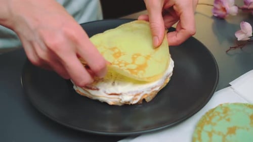 Hands Prepare Colorful Crepe Cake at Home