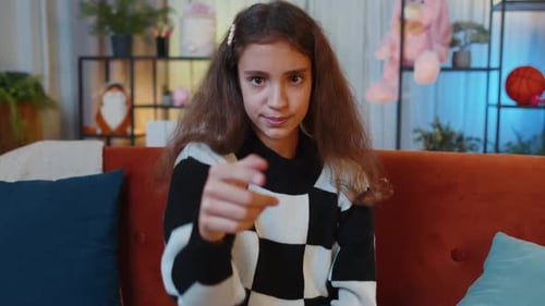 Preteen Girl Smiling Pointing to Camera Choosing Lucky Winner Indicating Inviting Approve at Home