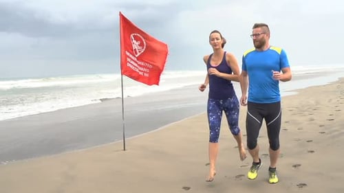Fit Couple Jogging on Beach Adult