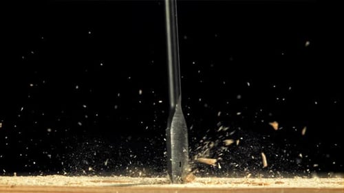 A Carpenter Drills a Hole in a Wooden Product Filmed on a Highspeed Camera at 1000 Fps