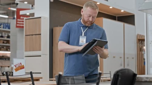 Man Checking Inventory of Furniture Store