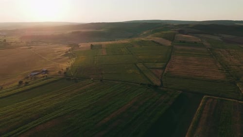 Stunning Aerial View of a Serene Agricultural Landscape Bathed in Beautiful Sunset Light