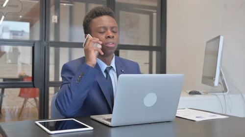 Young Adult Man On Phone in Modern Office