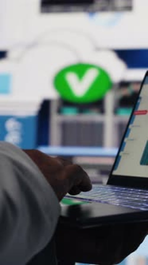 Vertical Video Black Business Manager Using His Laptop to Examine Fintech Insight