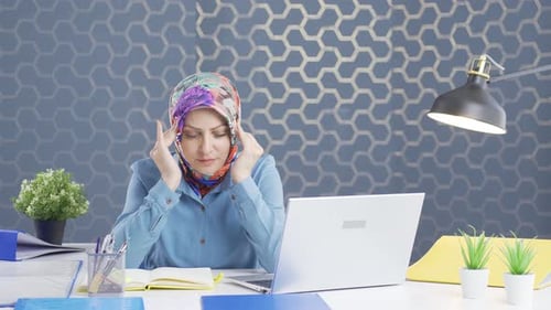 Hijab business woman with headache.