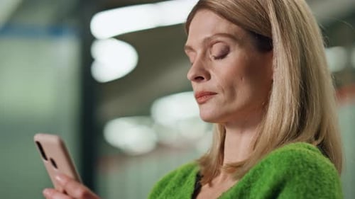 Confident Businesswoman Typing on Smartphone in Office